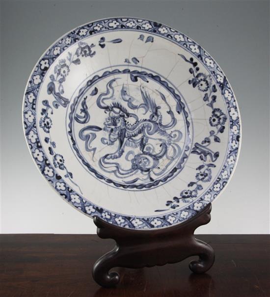 An Annamese blue and white dish, 15th / 16th century, 43cm, various cracks, rosewood stand